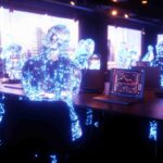 concetto di ambiente nel Metaverso con avatar che interagiscono con i siti WordPress tramite un laptop